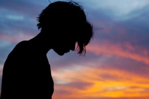 Silhouetted female in front of sunset sky